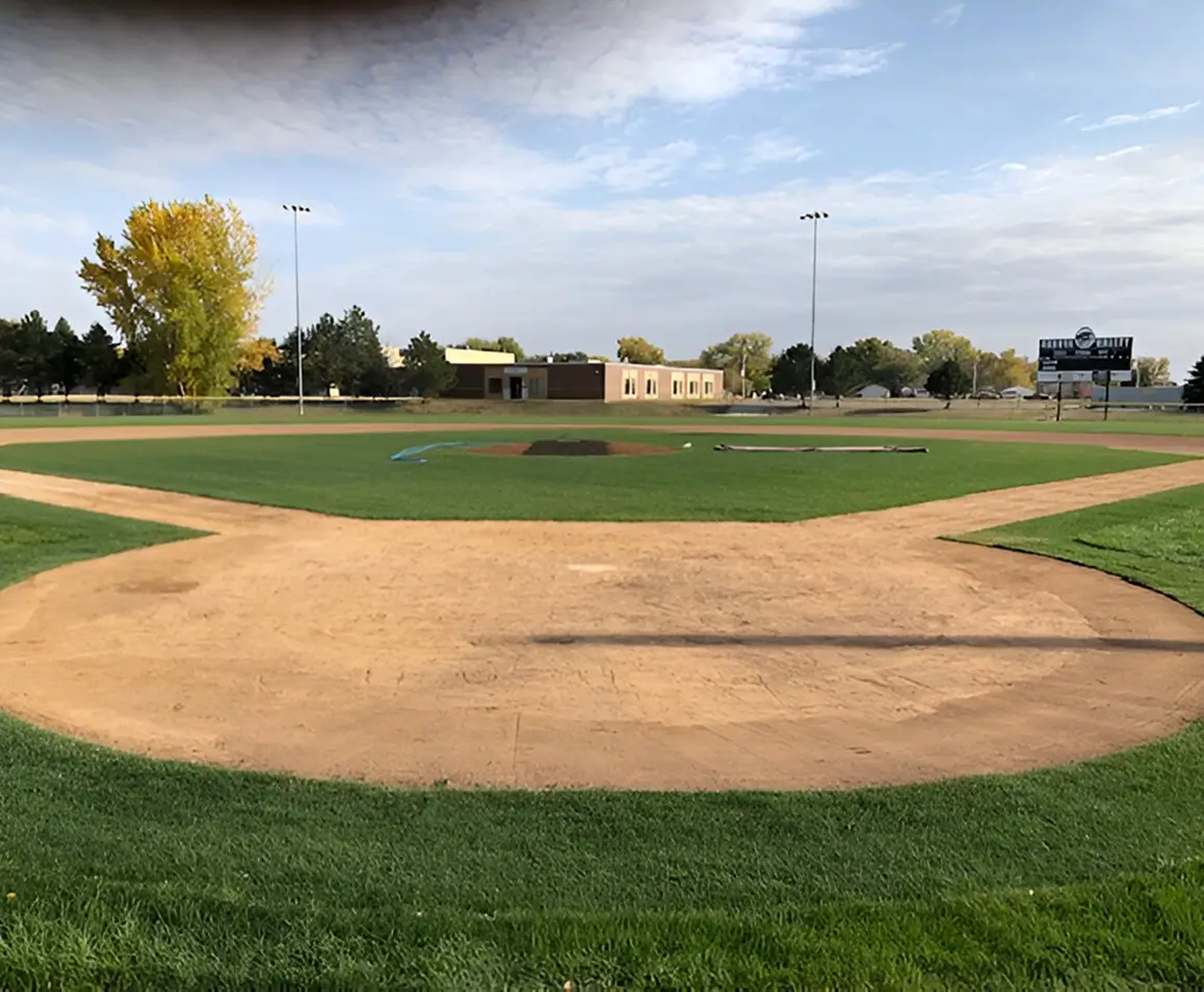 A baseball field with the base ball diamond in view.